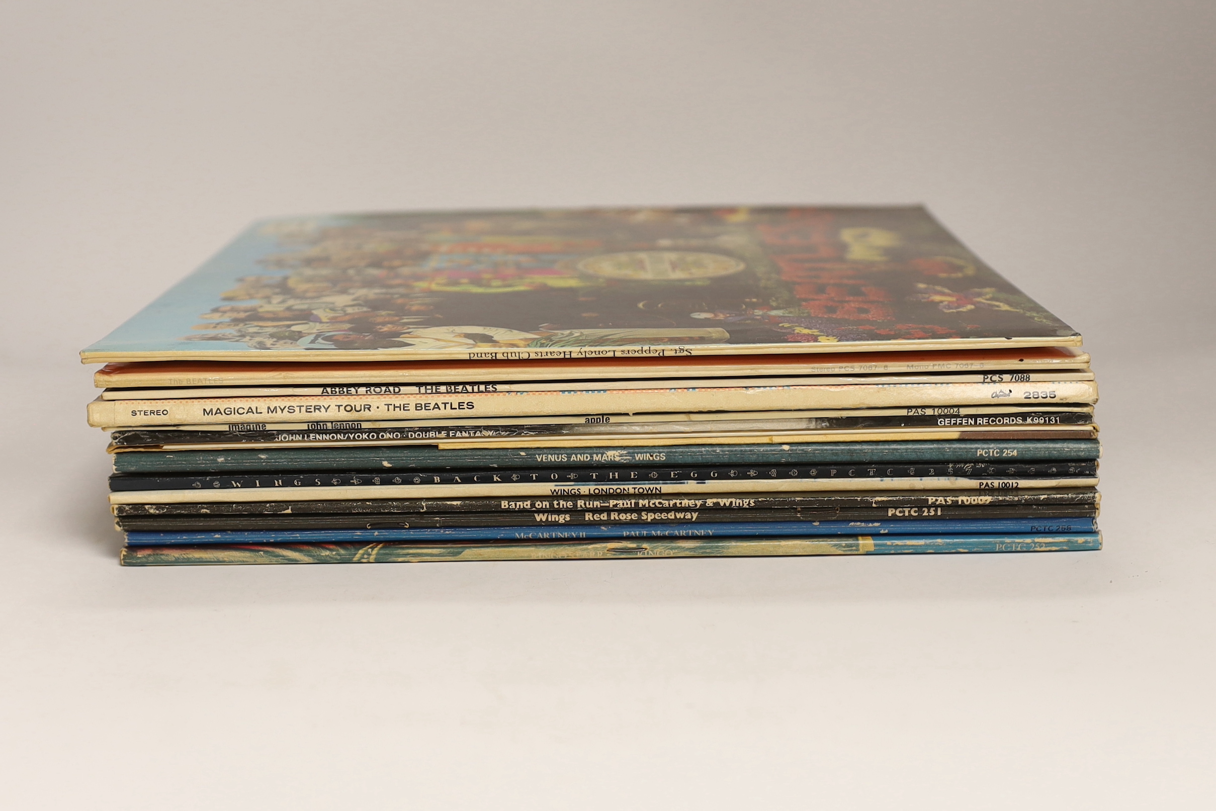 Fourteen The Beatles and related LP record albums including; Sergeant Pepper (with inserts), the White Album, Abbey Road, Magical Mystery Tour, etc.